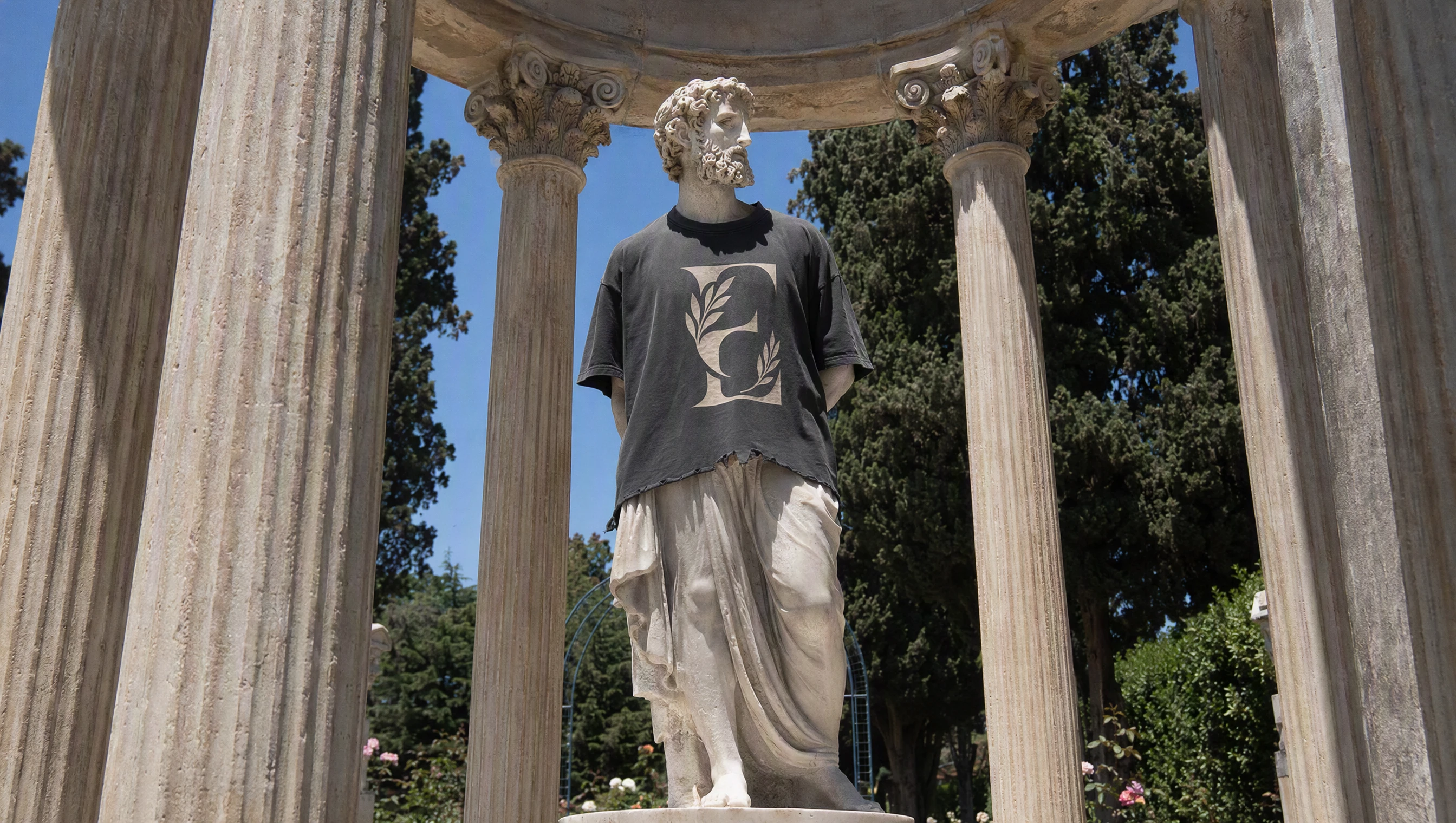 Classical statue wearing an Elysium training tee beneath Greek columns